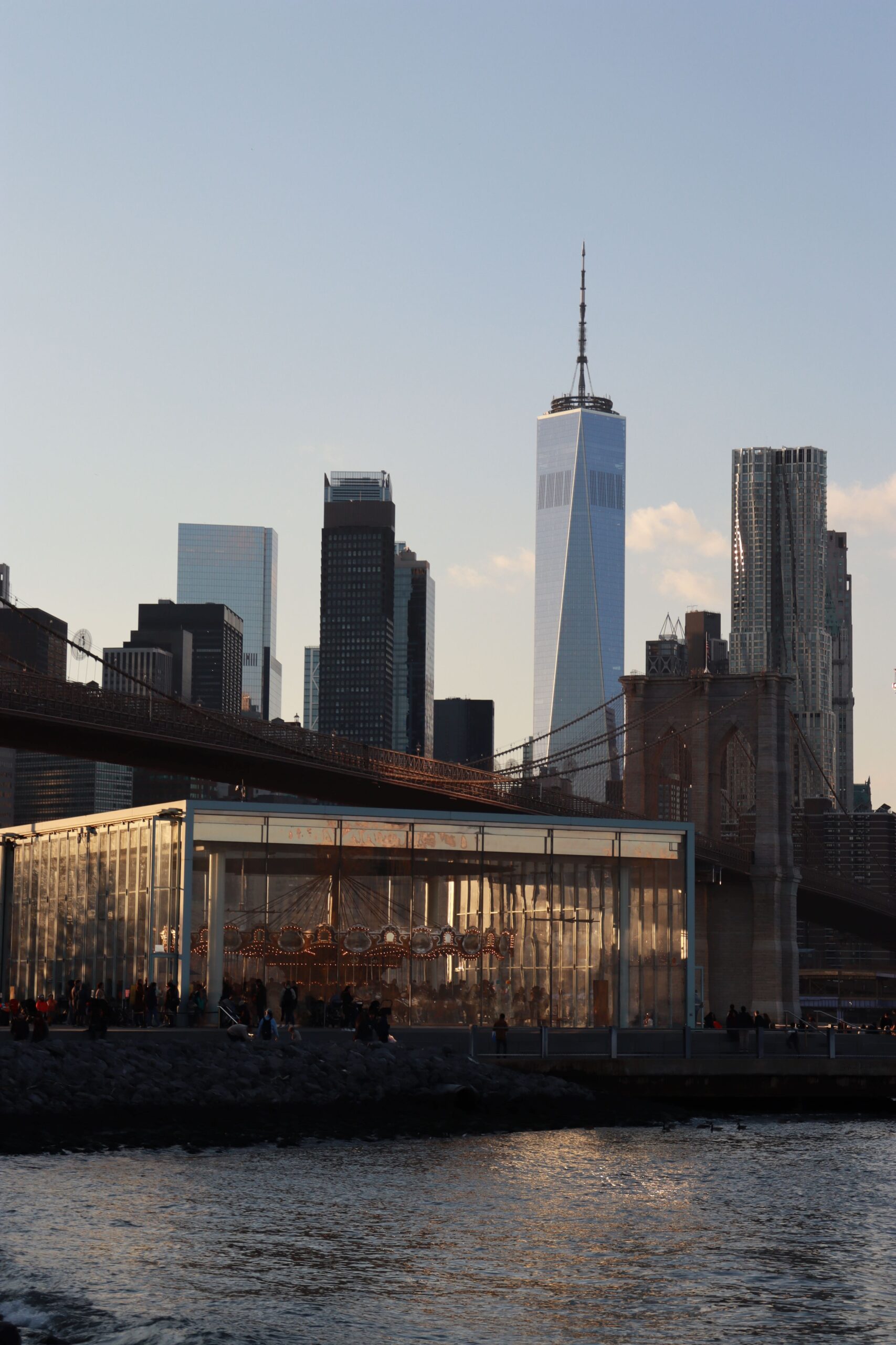 The view of the old carousel and the One World Trade Center Building from Dumbo Park, Brooklyn, New York.